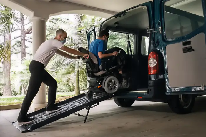 NDIS participant being comfortably assisted into a transport vehicle in Joondalup