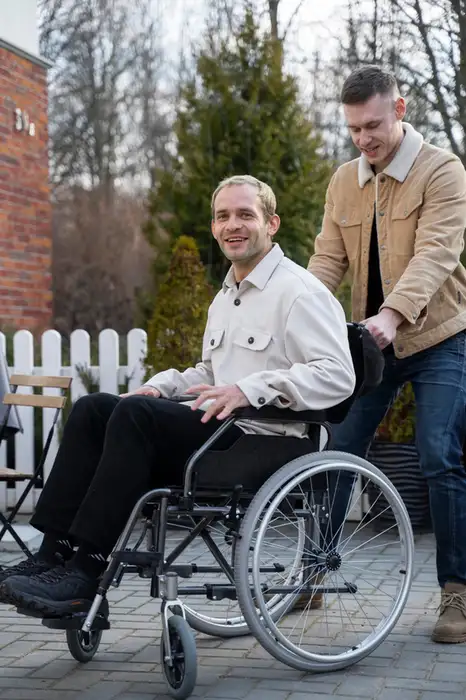 Support worker assisting a man in a wheelchair with compassionate NDIS disability support services in Armadale